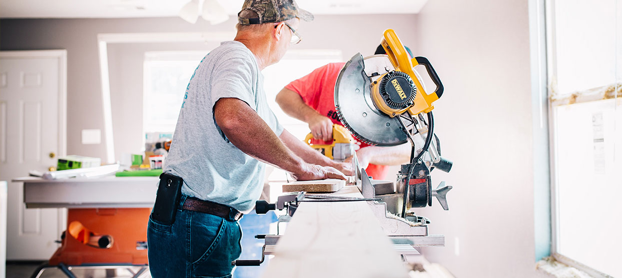 Older man working Hardwood floor sanding service